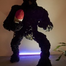 Gino Blanc, Kong plastic evolution, 2012, scultura con missile, polietine, ferro, CA2CO3, legno, bitume, colore ad olio, glitter, vetro, marmo, lingua mozzata, pianta in vaso, 230x120x110 cm., foto Giacomo De Dona