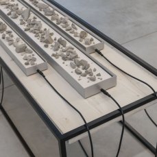 Stefano Caimi, Lithochronos, 49x56x200 cm, pietre, elettrovalvole, cavi, ferro, arduino, legno sbiancato, 2024